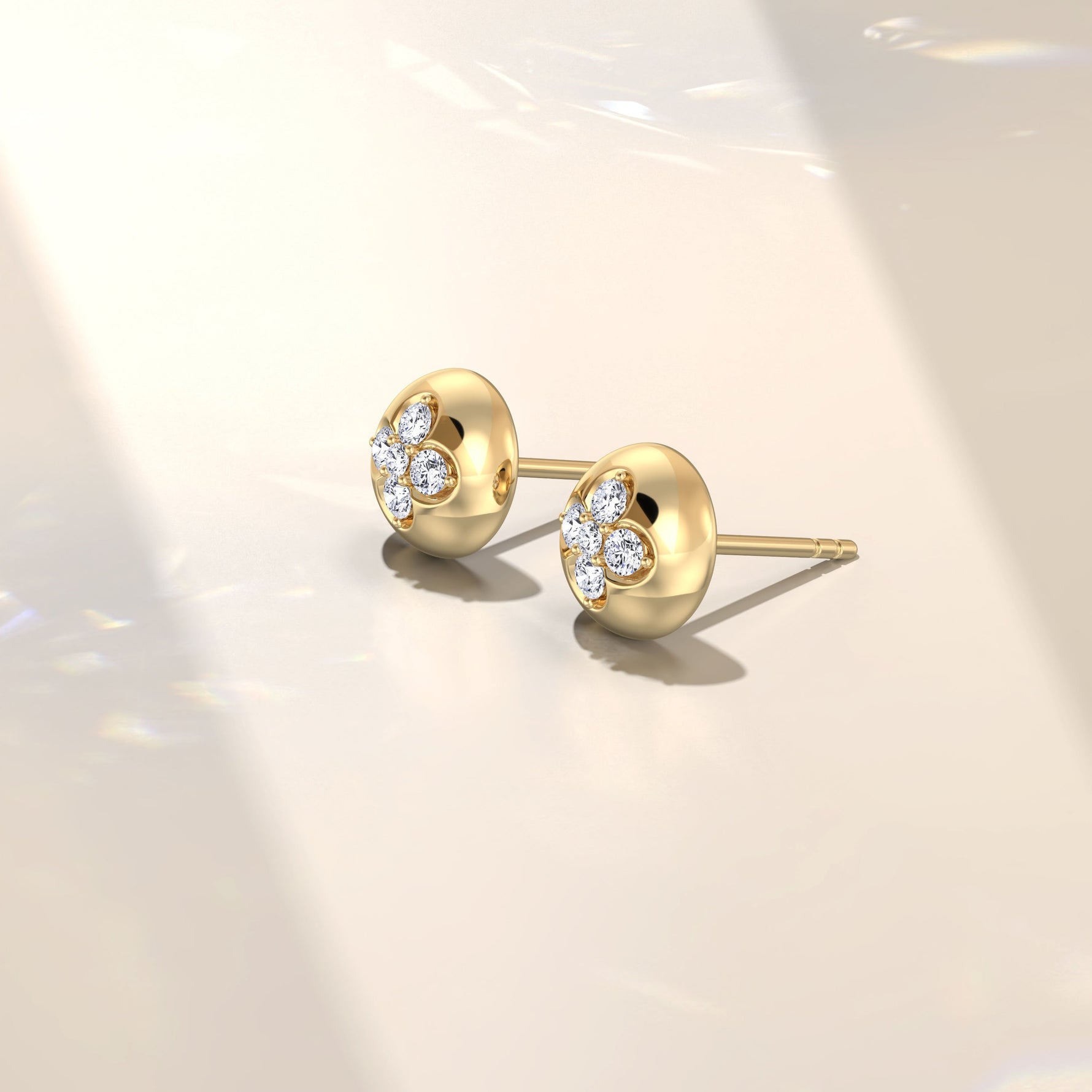 Pair of gold earrings with diamond accents on a light background